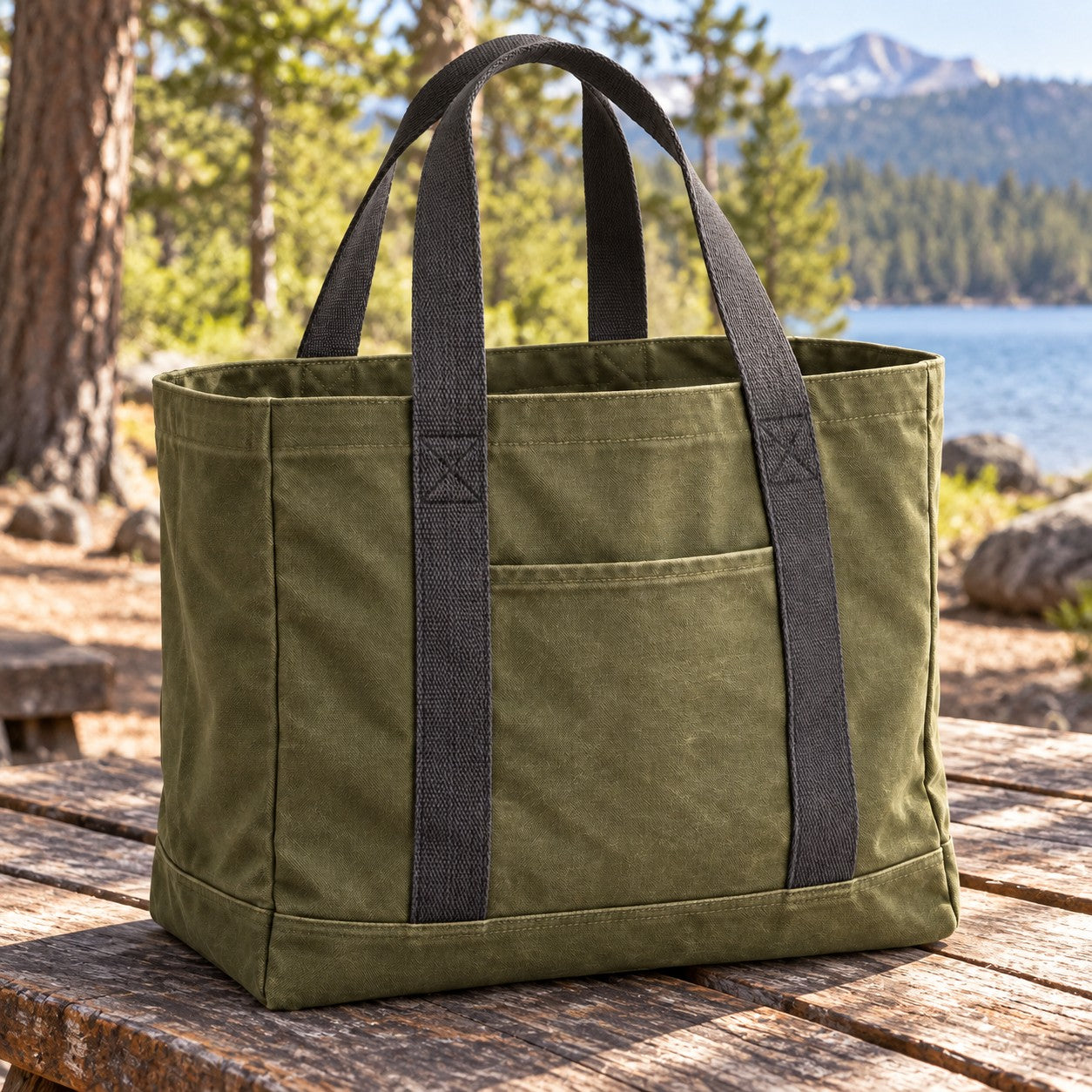 Olive gear tote on a wooden table outdoors